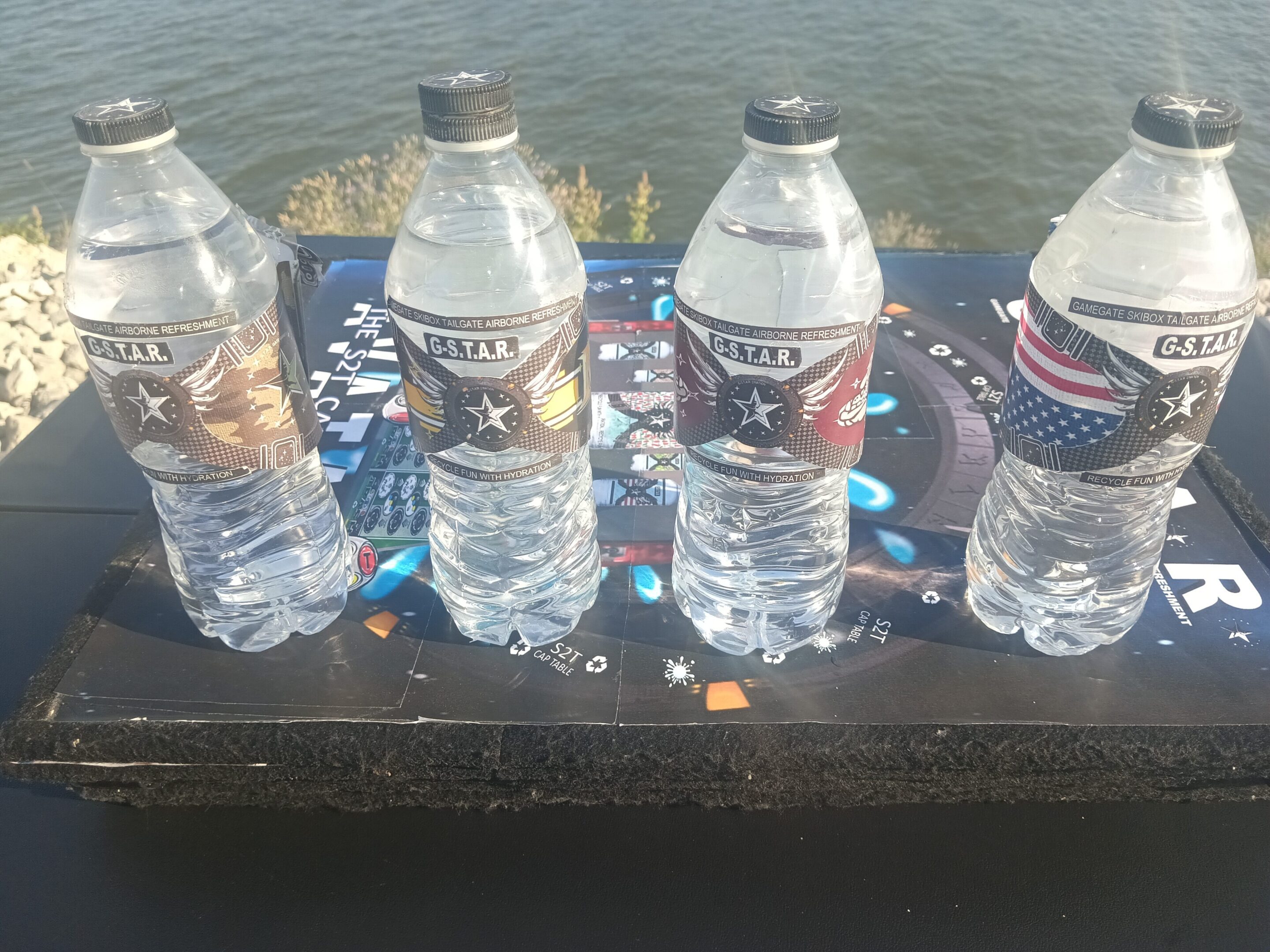 Four water bottles on a colorful table.